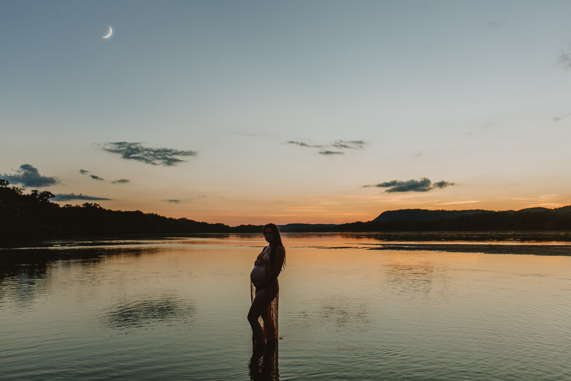 Madison, Wisconsin maternity photography by Jill Koskelin. Pregnant mother wading in the water by moonlight at sunset.