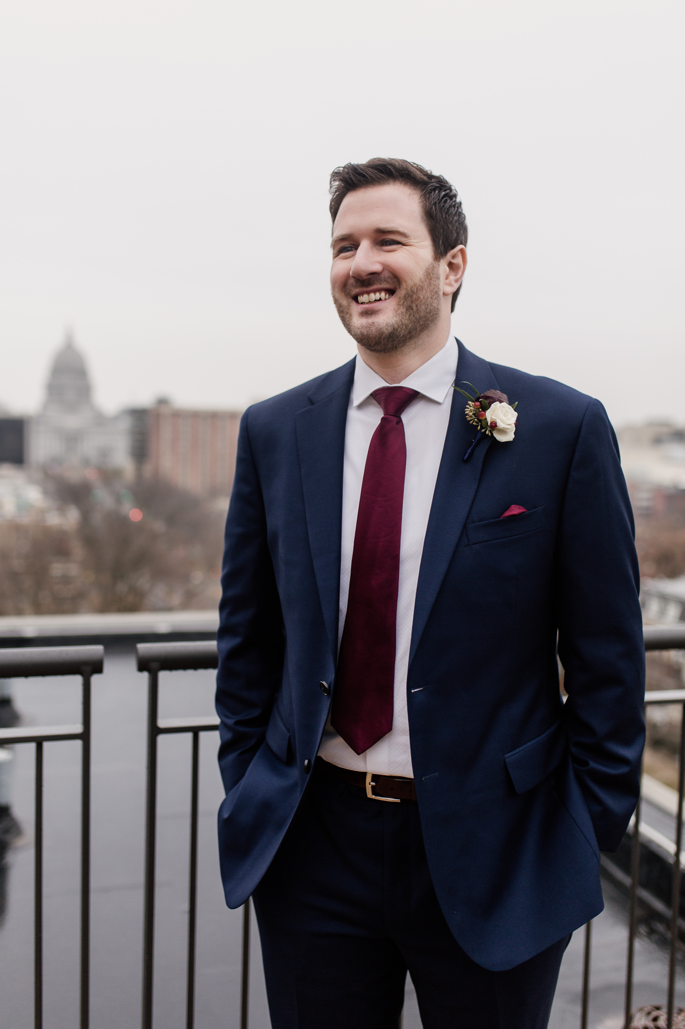 Groom standing on the rooftop of the Edgewater Hotel Madison, WI.