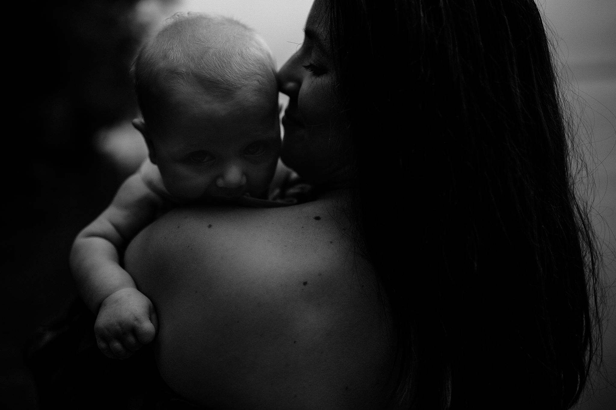 Madison Motherhood Photography. Mother holding her infant boy close to her face.