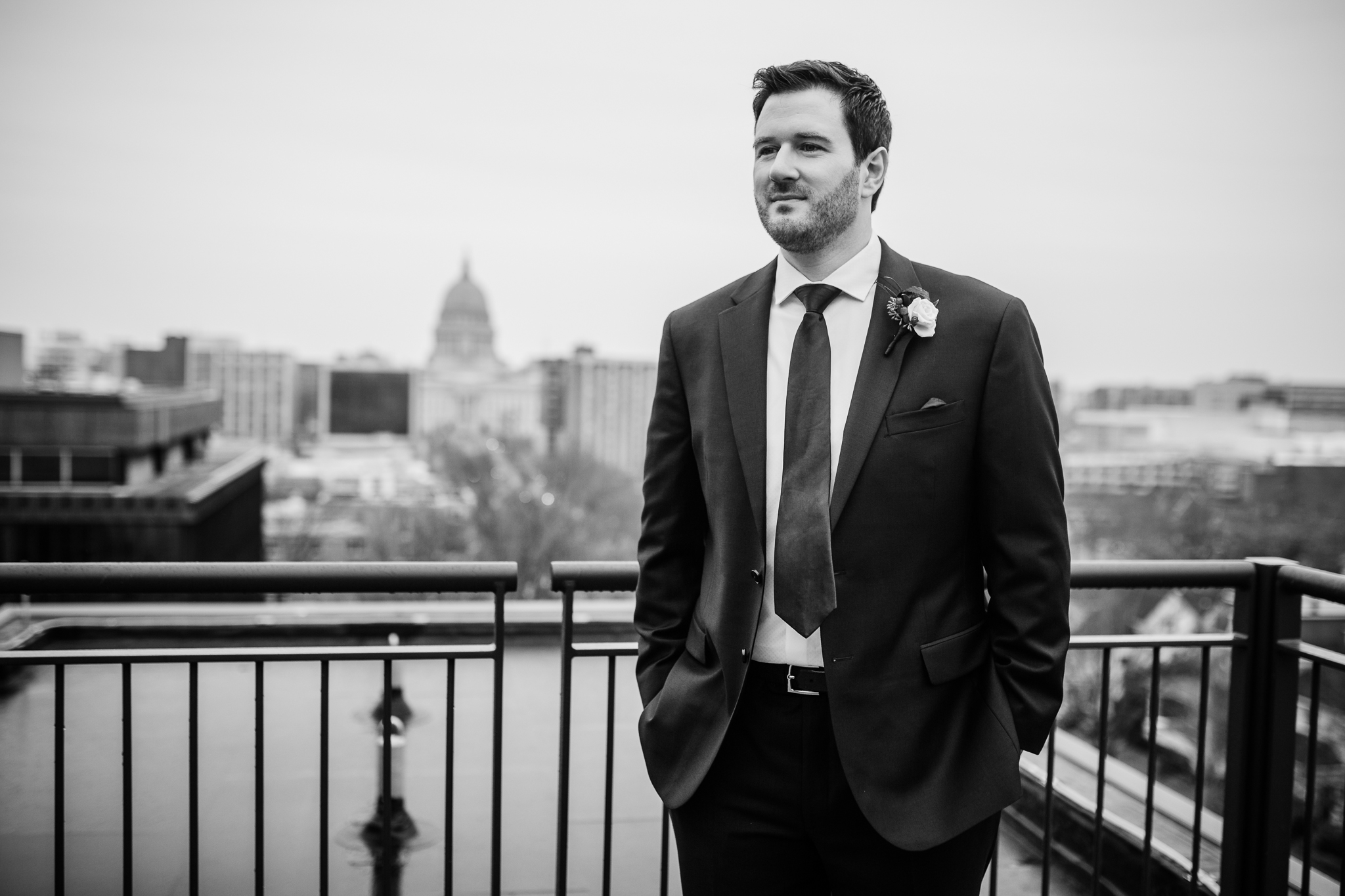 Groom standing on the rooftop of the Edgewater Hotel Madison, WI.