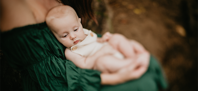 Baby nestled into mother's lap.