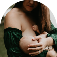 Mother breastfeeding her baby son near the Madison lakeshore.